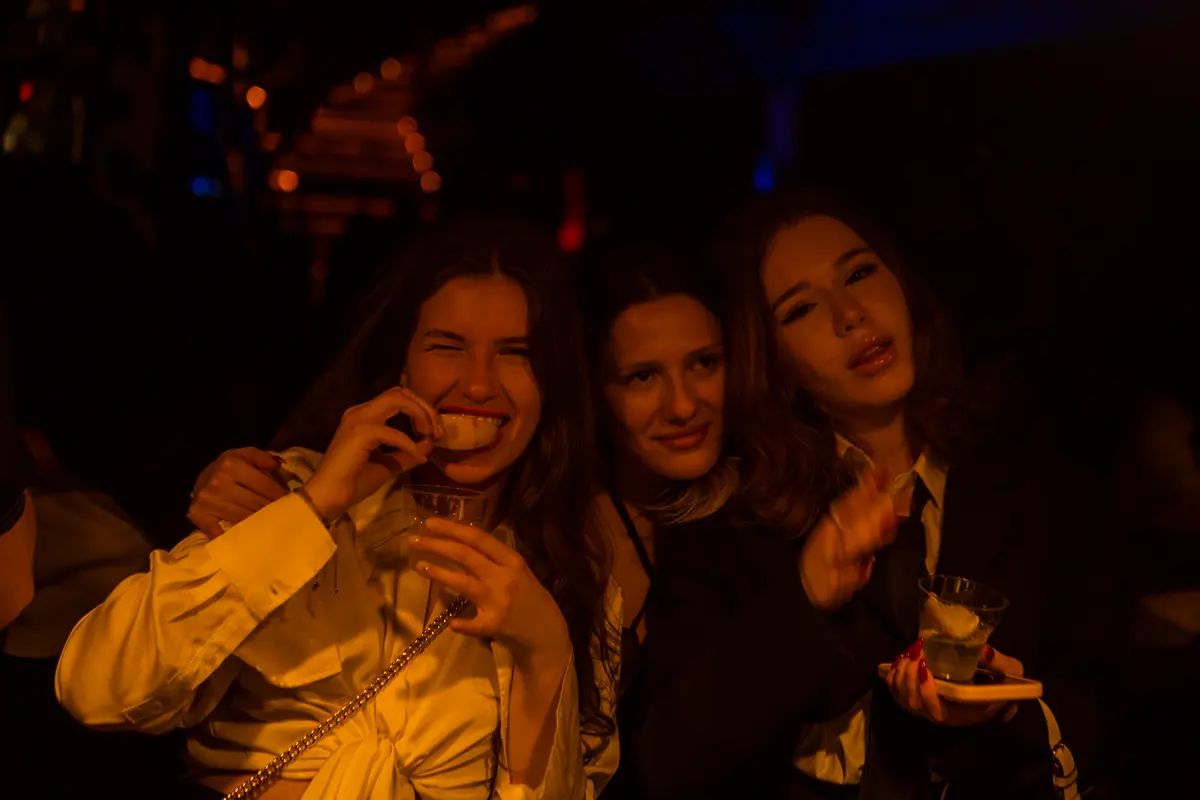 Friends laughing together at a Tbilisi birthday party